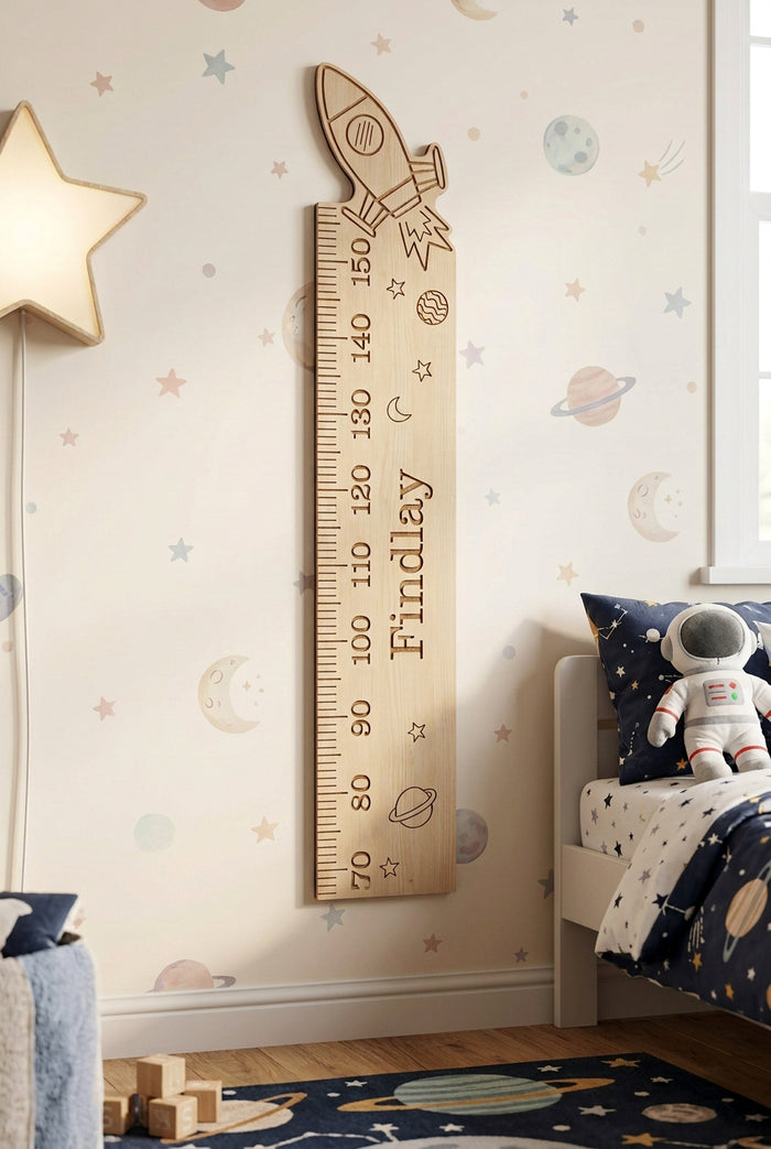 A wooden height chart with a rocket design on top, intended for recording children's height, with engraved measurements.